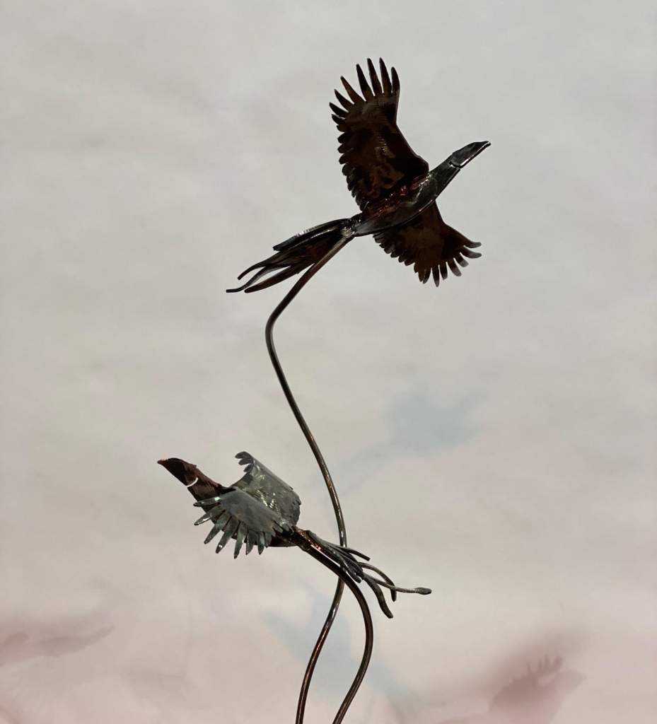 silver birds flying sculpture