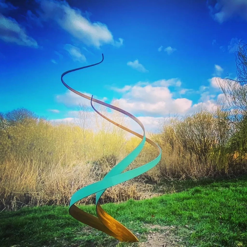large green and gold swirl sculpture