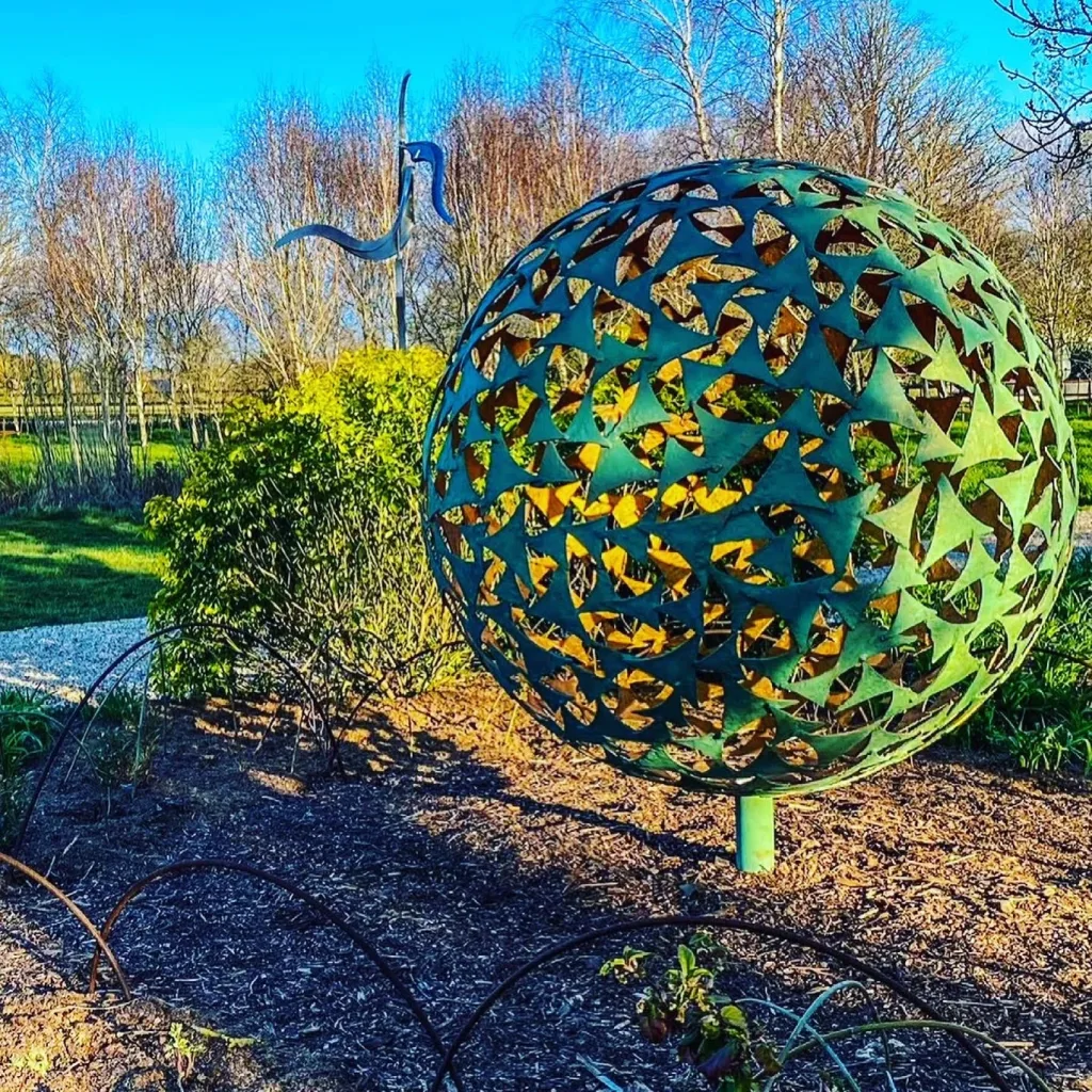 Green Sphere Sculpture In Field Of Sculptures