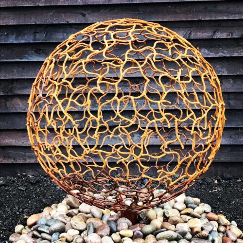 Rustic Sphere Sculpture On Rocks