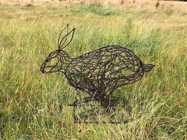 small rabbit running sculpture