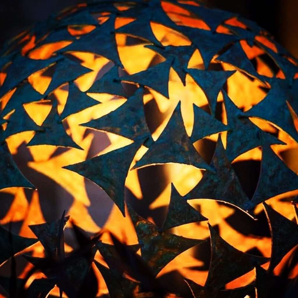 lights inside of a green sphere sculpture