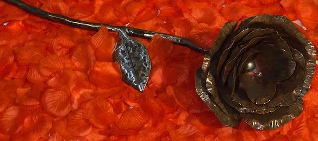 Handmade Copper Rose on red rose petals