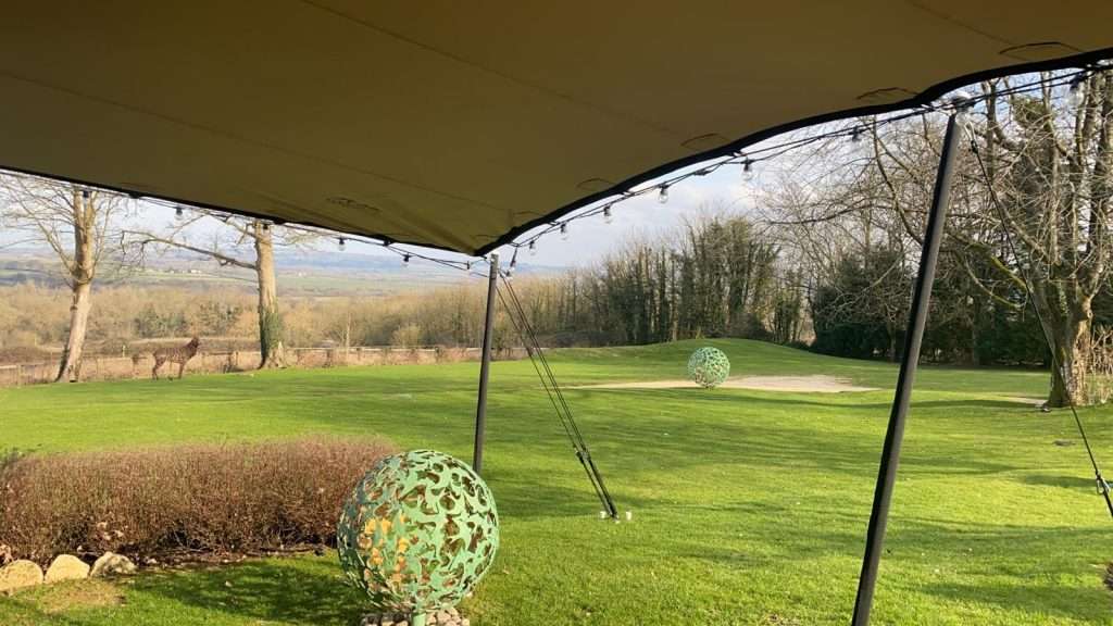 porch area covering a small green sculpture