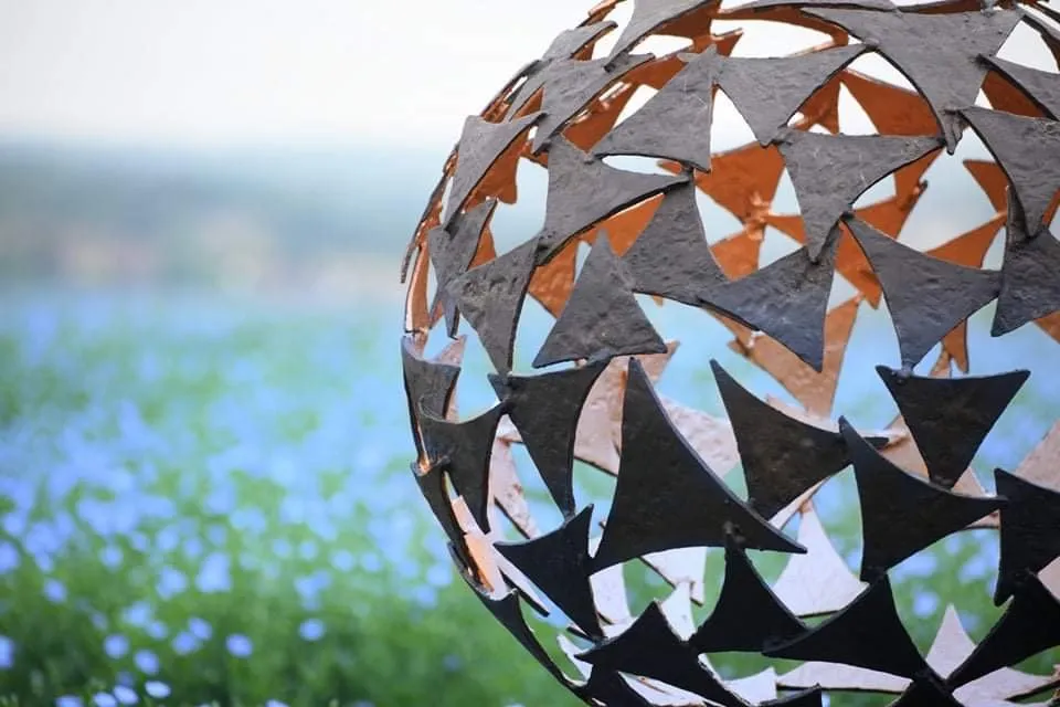side view sphere sculpture in flowers
