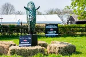 image of horse head sculpture and hay stacks
