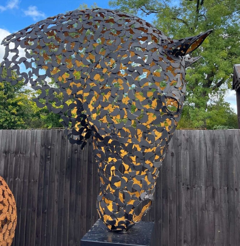 black and gold horse head sculpture close looking right