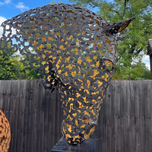 black and gold horse head sculpture close looking right