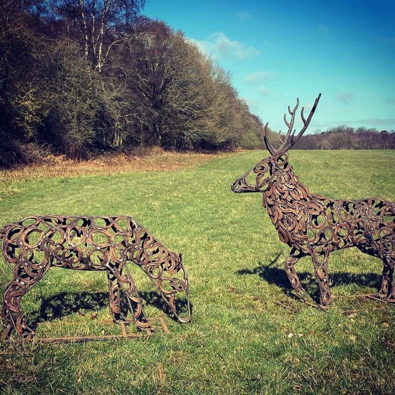 Stag and Doe Sculpture In A Field