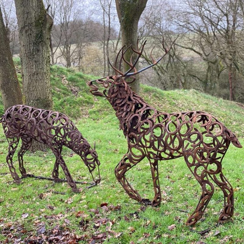 Stag and Doe Sculptures In Woods