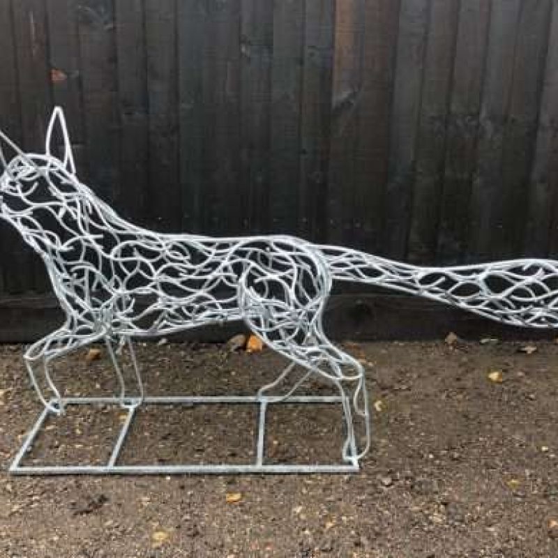 Galvanised Fox Sculpture Next To Wall