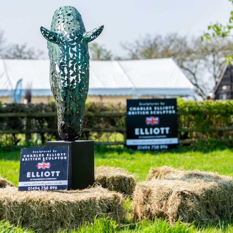 image of horse head sculpture and hay stacks