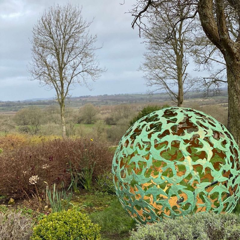 Swift Sphere Sculpture in wooded area