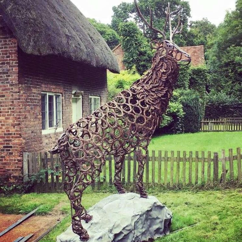 Stag Sculpture In Front Of Cottage