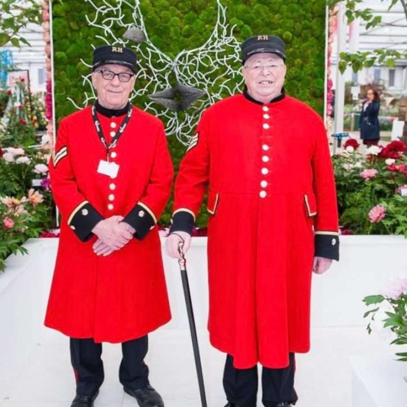 Two Men In Front Of Faces Structure