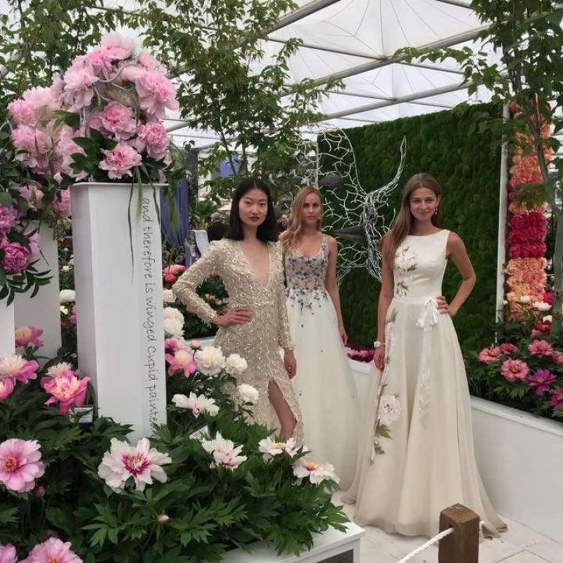 Three Women In Front Of Faces Structure