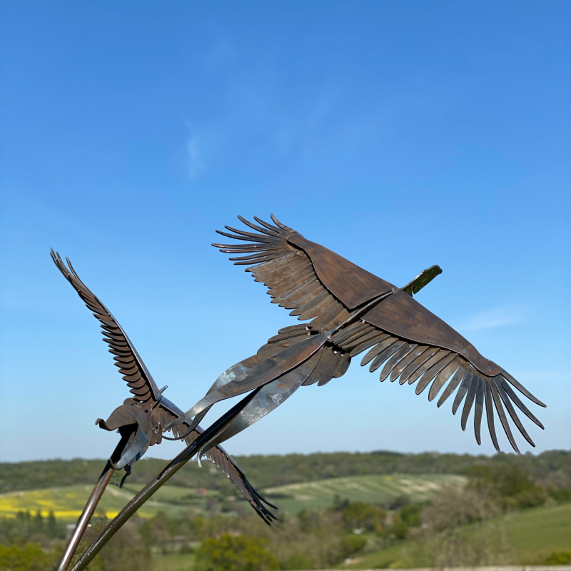 Birds Flying Sculpture In Field