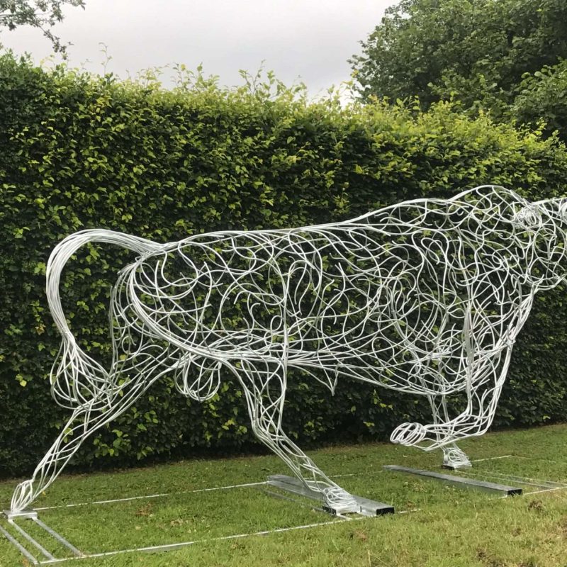 Bull Sculpture Next To Hedge